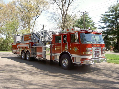 Front-right exterior view showing cab and elevated ladder structure
