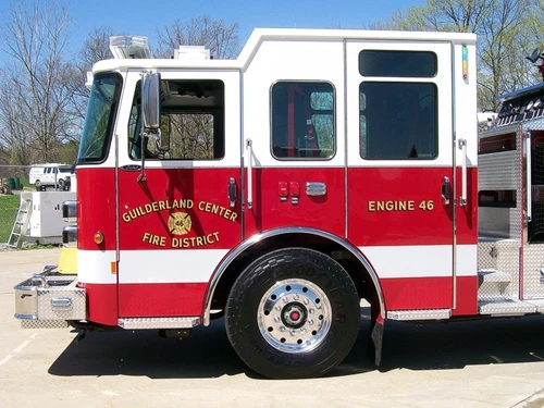 Cab side close-up showing door logo, side window, and front wheel