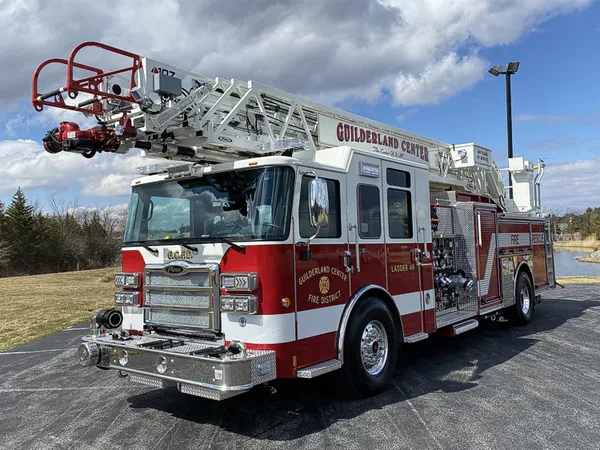 Tower ladder truck front-left exterior view showing cab and aerial sections