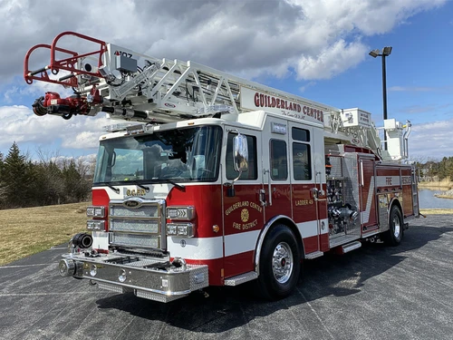 Tower ladder truck front-left exterior view showing cab and aerial sections