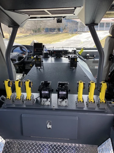Rear crew-seat close-up showing SCBA mounts and seat restraints
