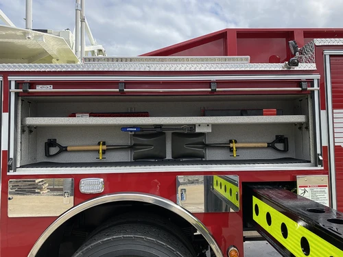 Open side compartment showing mounted hand tools in horizontal rack