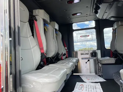Cab interior rear-seat view showing bench seating and side windows