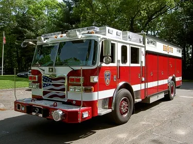 Front-left exterior view of heavy rescue truck showing cab, bumper winch, and side body