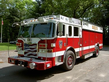 Front-left exterior view of heavy rescue truck showing cab, bumper winch, and side body