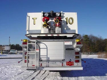 Direct rear view showing bucket base, rear roll-up door, and warning lights