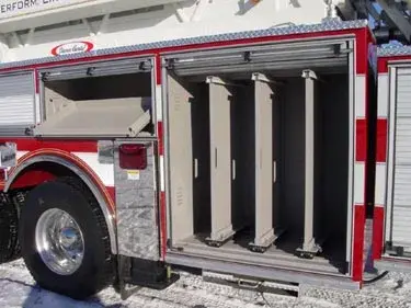 Open side compartment showing vertical ladder and pike pole storage slots