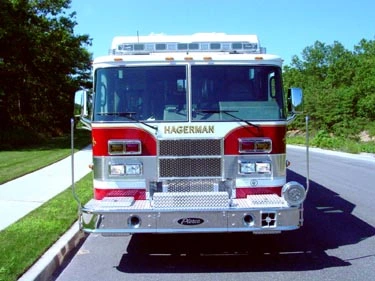 Head-on front view showing grille, bumper, and roof warning lights