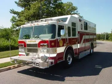 Front-right exterior view showing cab, wheel area, and side body compartments
