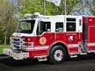 Pierce rescue pumper front-left exterior view with bumper, cab, and side compartments