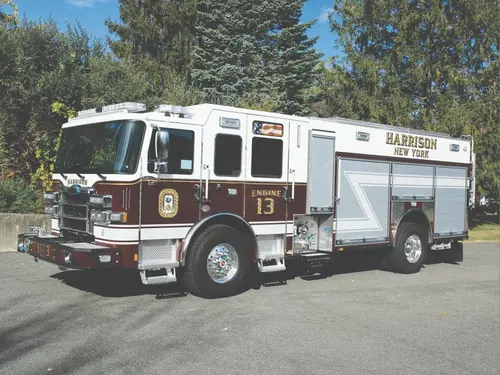 Pierce Enforcer pumper front-left exterior view with enclosed cab and side compartments