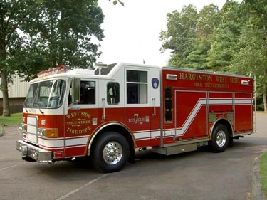 Rescue pumper driver-side profile view showing enclosed cab and side compartments