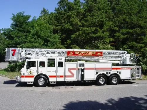 Straight driver-side profile of the ladder truck with stowed aerial and full wheelbase visible.