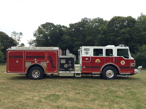 Driver-side full profile showing the midship pump panel, side compartments, and wheel area.