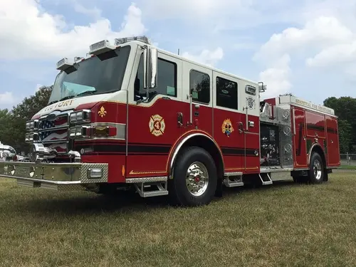 Front-left three-quarter view highlighting the chrome grille, cab, pump panel, and side body.