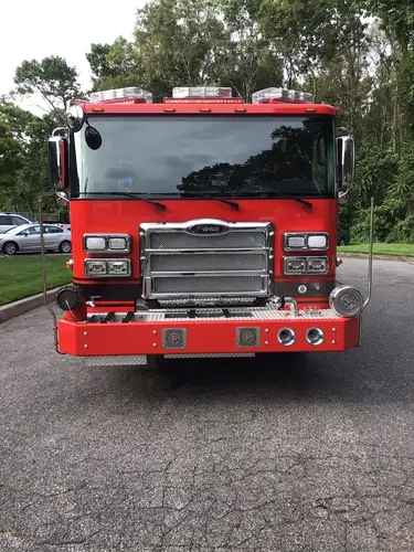 Head-on front exterior view showing grille, bumper, and warning lights