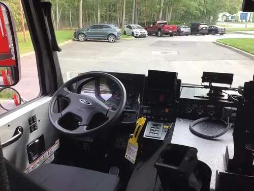 Driver cockpit close-up showing wheel, gauges, and center control panel