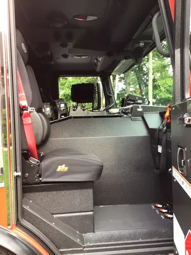 Cab side-entry view showing front seats and center console area