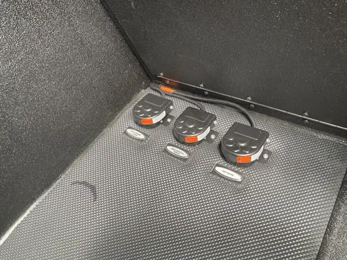 Crew seat side close-up showing blue SCBA bracket mount