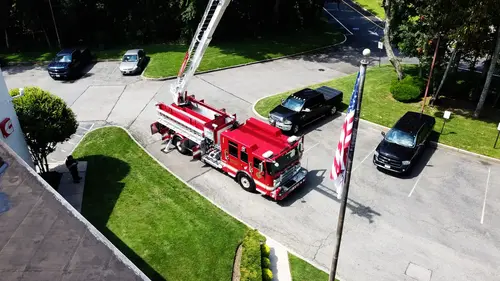 Aerial ladder truck front view showing grille, warning lights, and bumper intakes