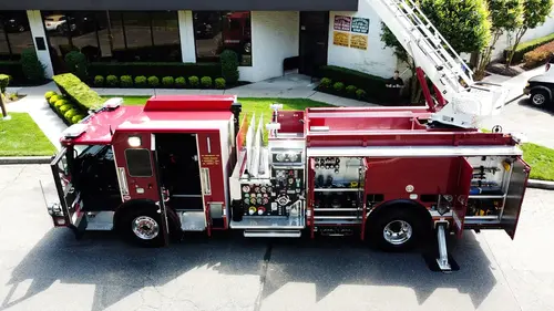 Front-left low-angle view showing front wheel, bumper trim, and cab side