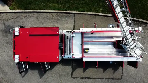 Open side compartment view showing slide-out trays and mounted tool storage