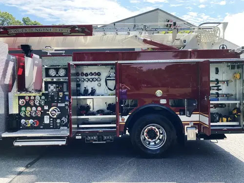 Aerial ladder section close-up showing nested ladder rails and side striping