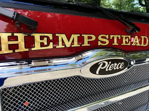 Body side logo close-up showing emblem decal on compartment door