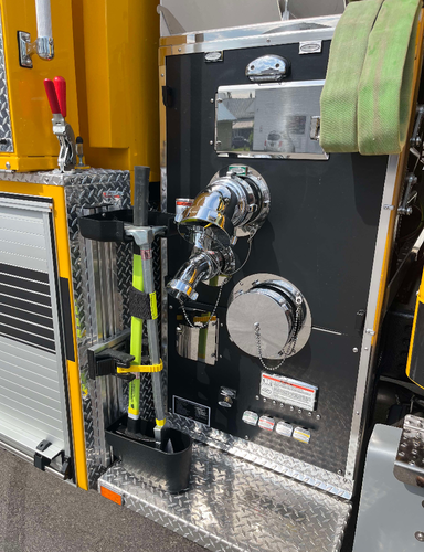 Pump panel and intake close-up showing side connections and mounted hand tools