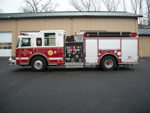 Full left-side profile highlighting the pump panel, wheel areas, and side compartment doors.