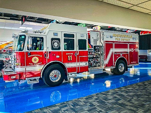 Pumper front-left exterior view showing grille, bumper, and side compartments