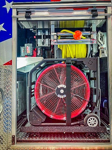 Open side compartment showing ventilation fan and stored equipment bins