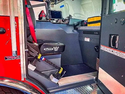 Cab interior side view showing rear seat and center console area
