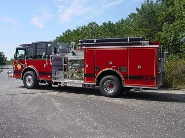 Black-cab pumper driver-side profile showing side body and pump panel area