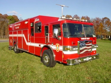 Hazmat truck front-left exterior view showing enclosed cab and long body