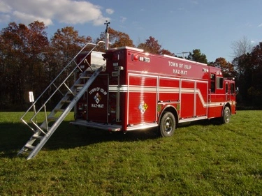 Rear-left exterior view showing deployed access ladder and rear body