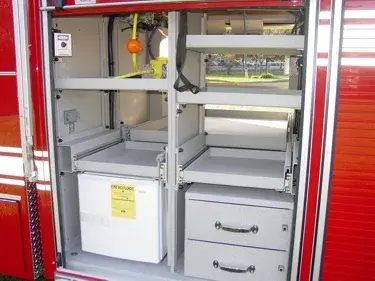 Open side compartment showing shelves, drawers, and equipment storage