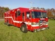 Hazmat truck front-left exterior view showing enclosed cab and long body