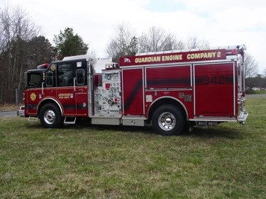 Red pumper driver-side profile showing pump panel and side compartments