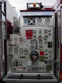 Pump panel close-up showing gauges, valves, and control levers