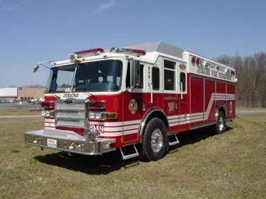 Heavy rescue truck front-left exterior view showing enclosed cab and long body