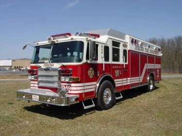 Heavy rescue truck front-left exterior view showing enclosed cab and long body