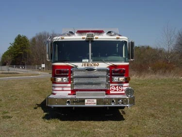 Head-on front view showing grille, bumper, and warning lights