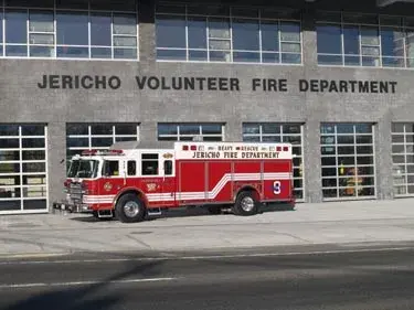 Front station view showing heavy rescue truck parked near bay doors