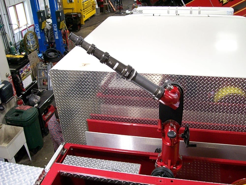 Top deck close-up showing deck-mounted monitor base and polished platform