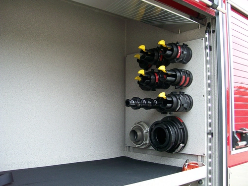 Open side compartment showing port fittings and capped connection points