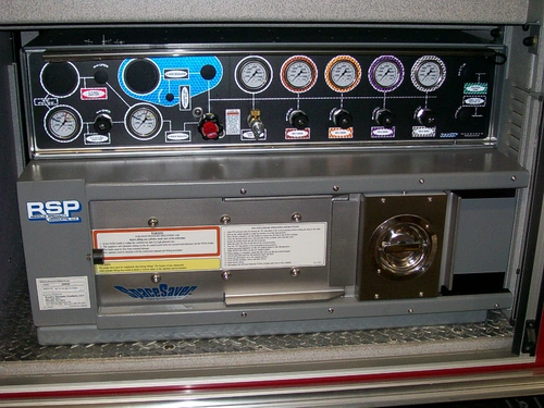 Control panel close-up showing gauges, labels, and equipment ports