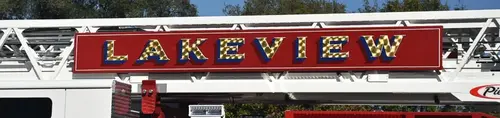 Close-up of large ladder-side logo panel with gold lettering