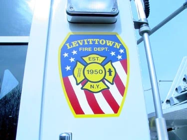 Cab-side crest close-up on white panel above door handle