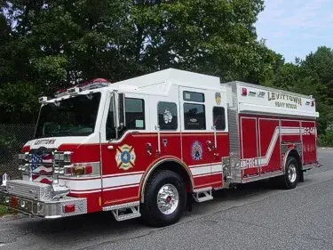 Front-left exterior view of heavy rescue truck showing chrome bumper and long side body
